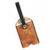 The back of the leather luggage tag with green strap